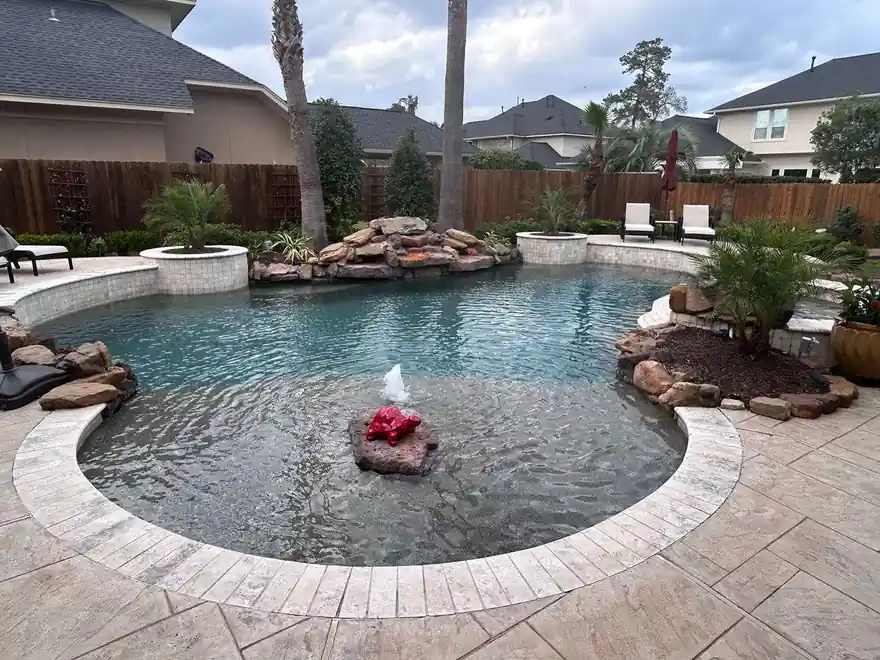 Beach-entry pool with a sculptural water feature and a fresh interior finish