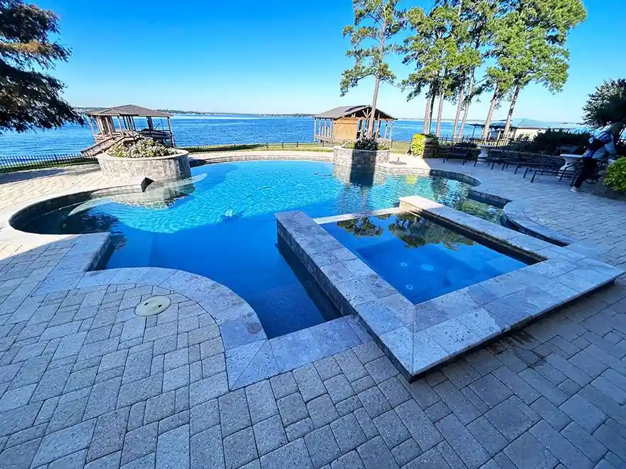 Wide view of a lakefront pool with saturated blue water