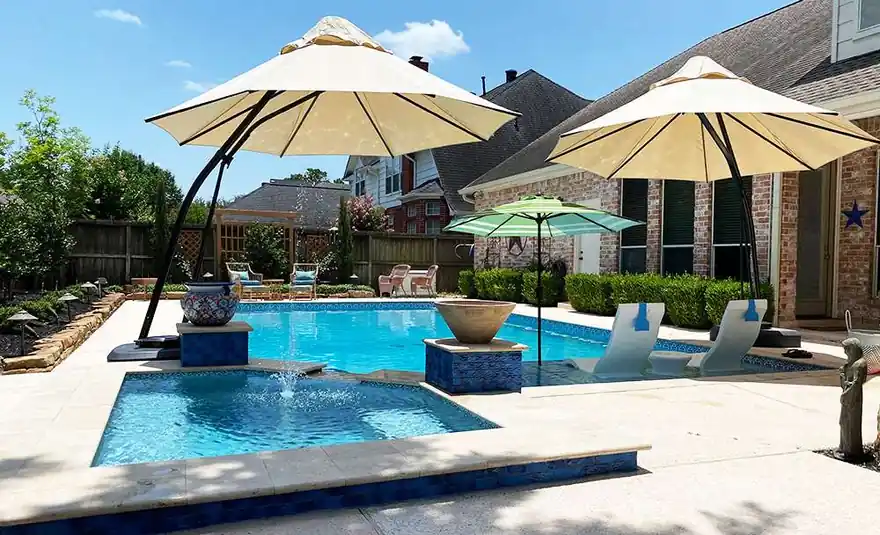 Pool with a tanning ledge and shade umbrellas